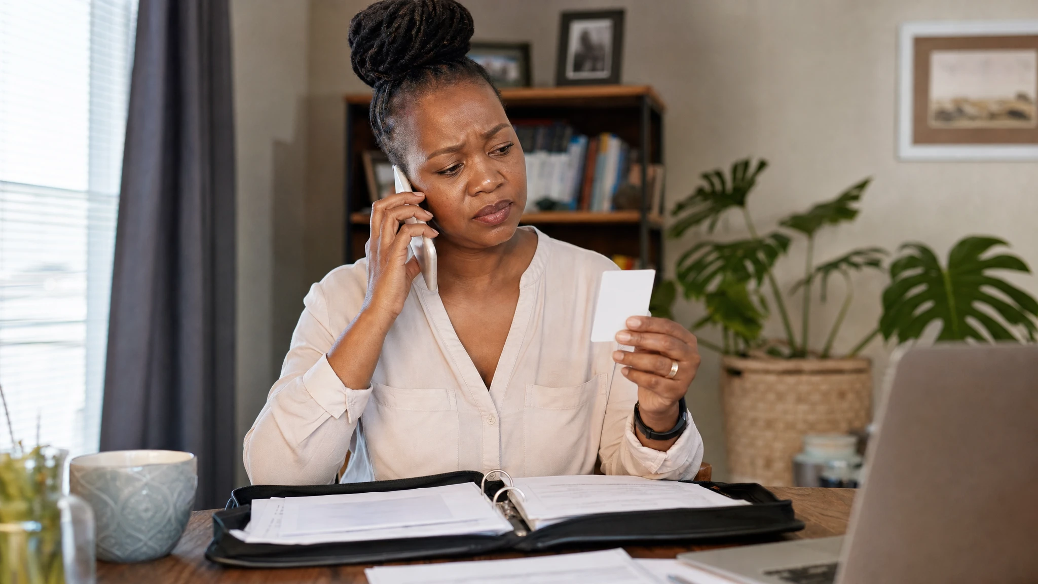 Mounjaro medical aid cover: woman phoning her scheme with her membership card in hand